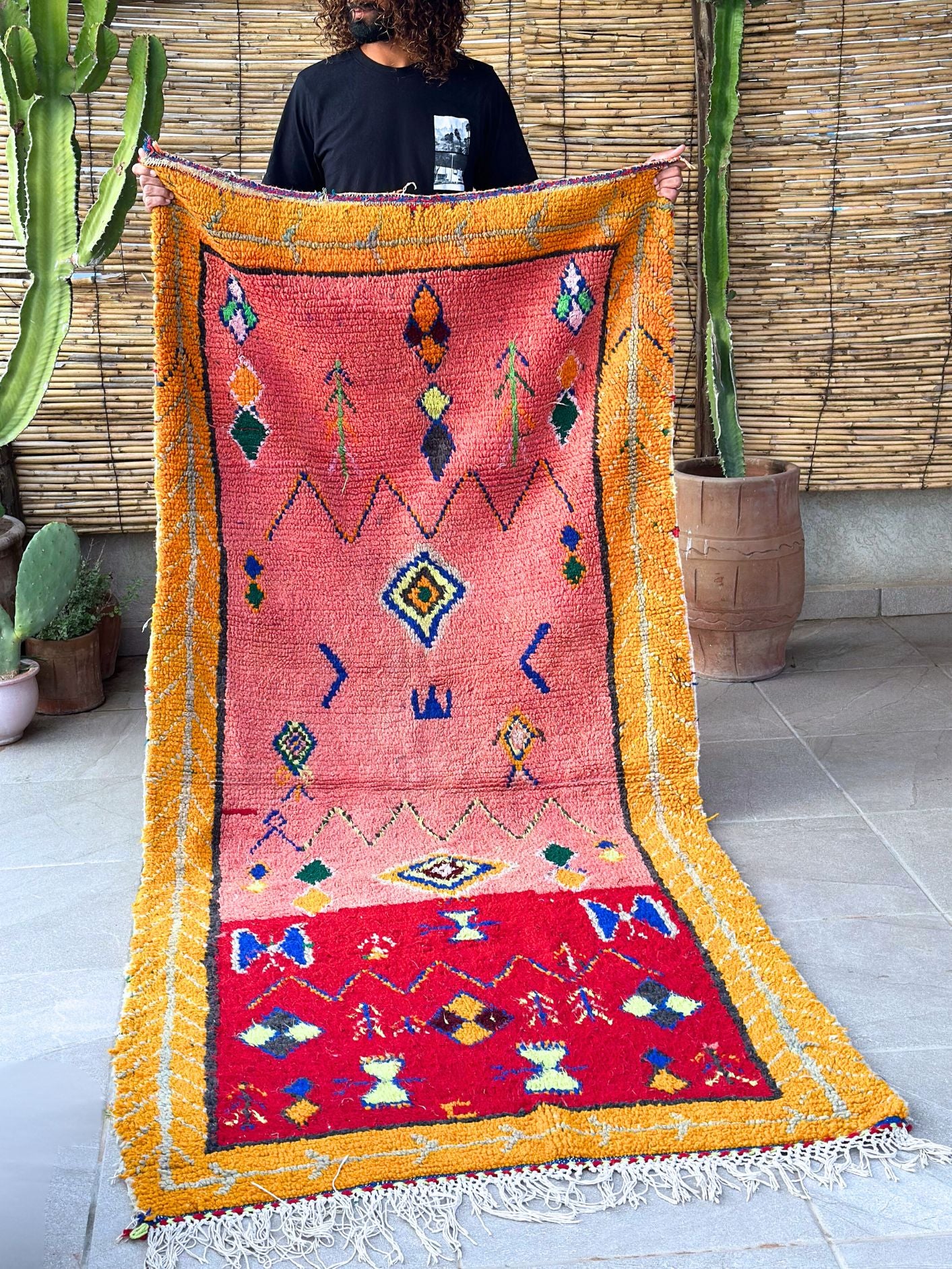 This handwoven Moroccan runner rug with bold red, yellow, and pink hues, featuring geometric Berber motifs is Perfect for boho, modern, contemporary or eclectic interiors. The motifs include diamond (symbolizing protection), zig zag mountain lines, and hourglass shaped butterflies