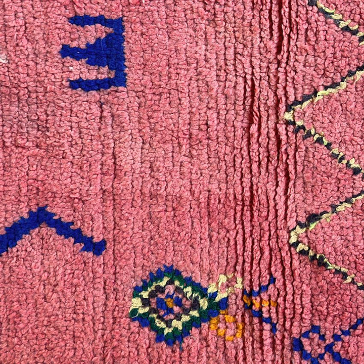 This handwoven Moroccan runner rug with bold red, yellow, and pink hues, featuring geometric Berber motifs is Perfect for boho, modern, contemporary or eclectic interiors. The motifs include diamond (symbolizing protection), zig zag mountain lines, and hourglass shaped butterflies