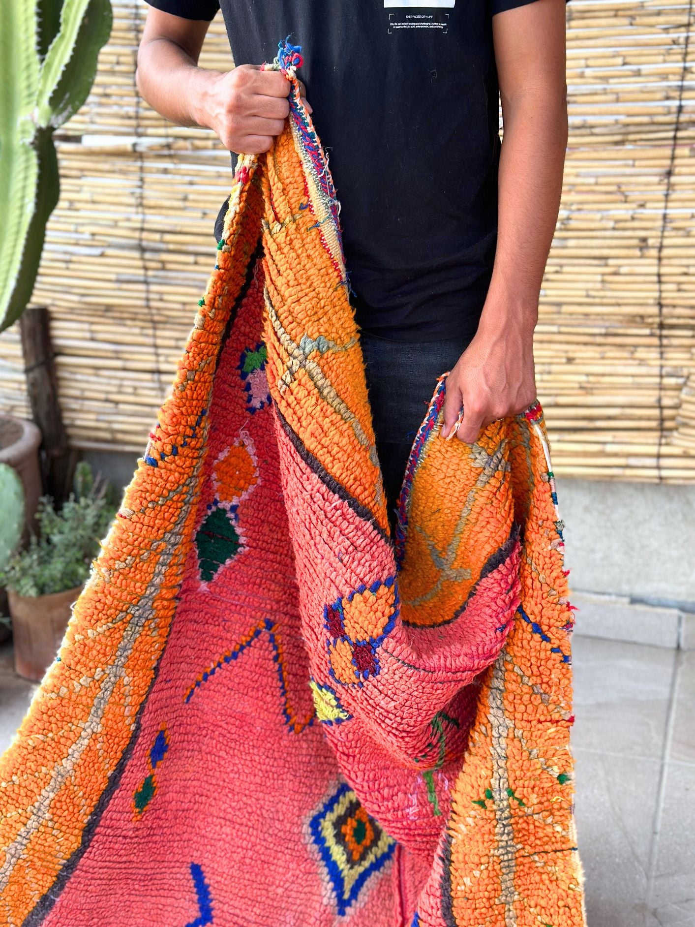 This handwoven Moroccan runner rug with bold red, yellow, and pink hues, featuring geometric Berber motifs is Perfect for boho, modern, contemporary or eclectic interiors. The motifs include diamond (symbolizing protection), zig zag mountain lines, and hourglass shaped butterflies